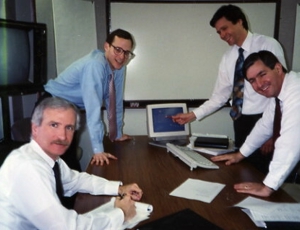 Advantage Computing Systems Business Analysts gathered around a table